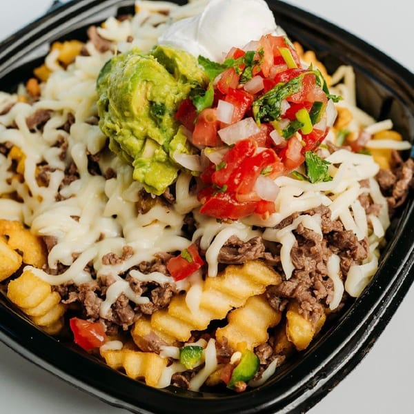 Loaded fries with melted cheese, ground beef, guacamole, pico de gallo, and sour cream.